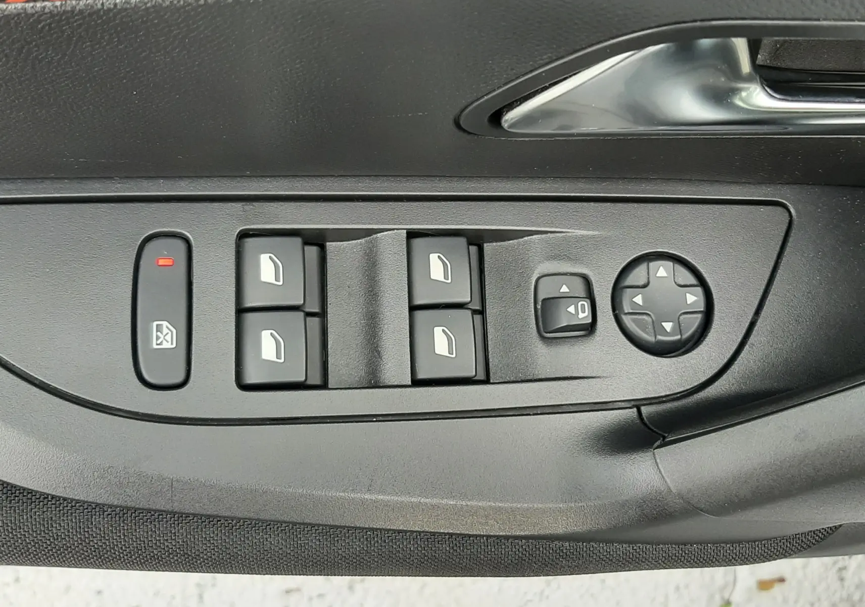 Panneau de commandes des vitres et rétroviseurs côté conducteur d'une Peugeot 2008 blanche, avec insert décoratif orange.