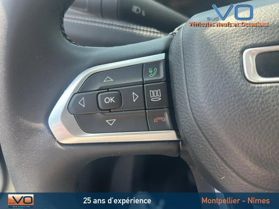 Gros plan sur les commandes au volant du Jeep Compass blanc 2024, version e-Hybrid Altitude.