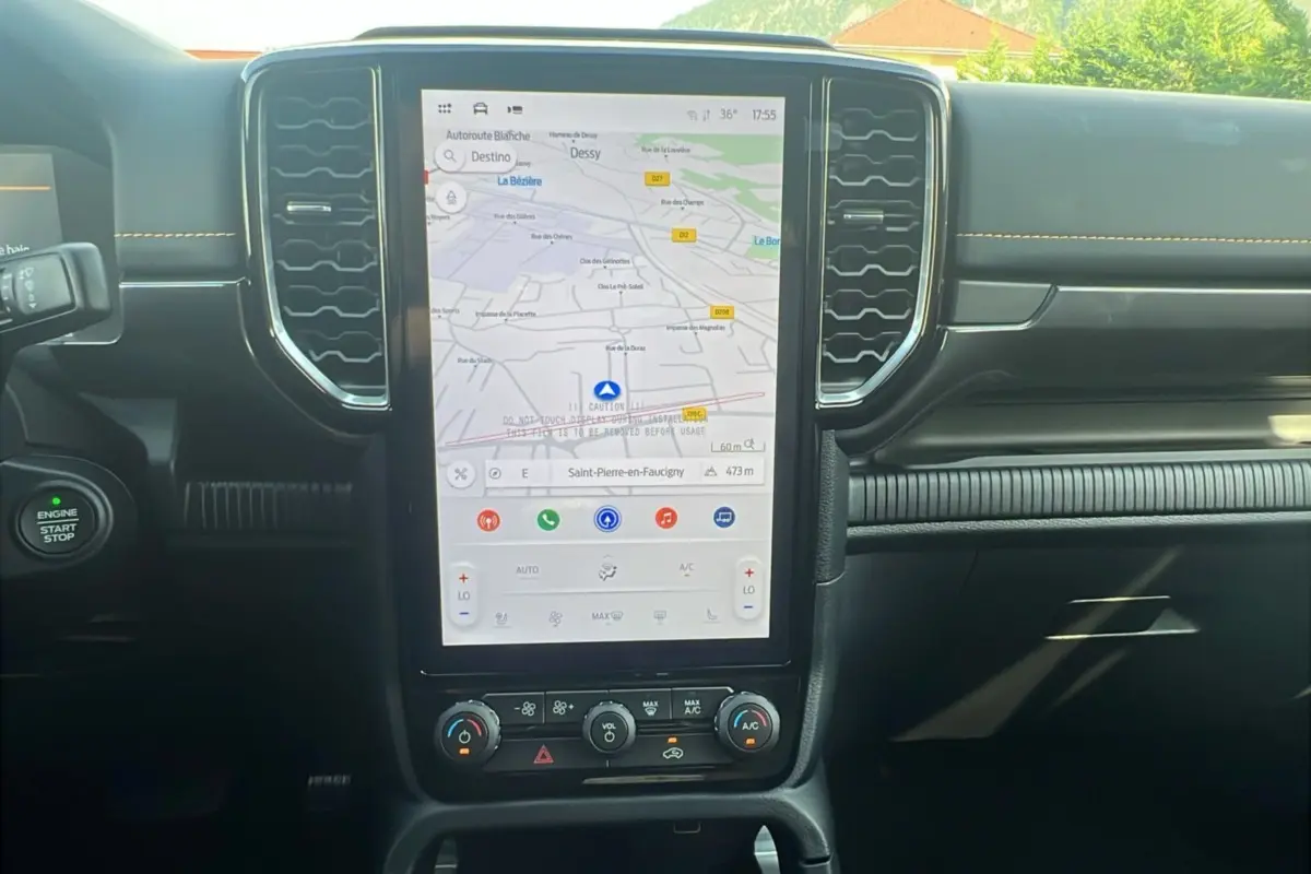 Vue rapprochée de la console centrale du Ford Ranger Wildtrak 2025 avec écran tactile GPS et commandes climatisation.