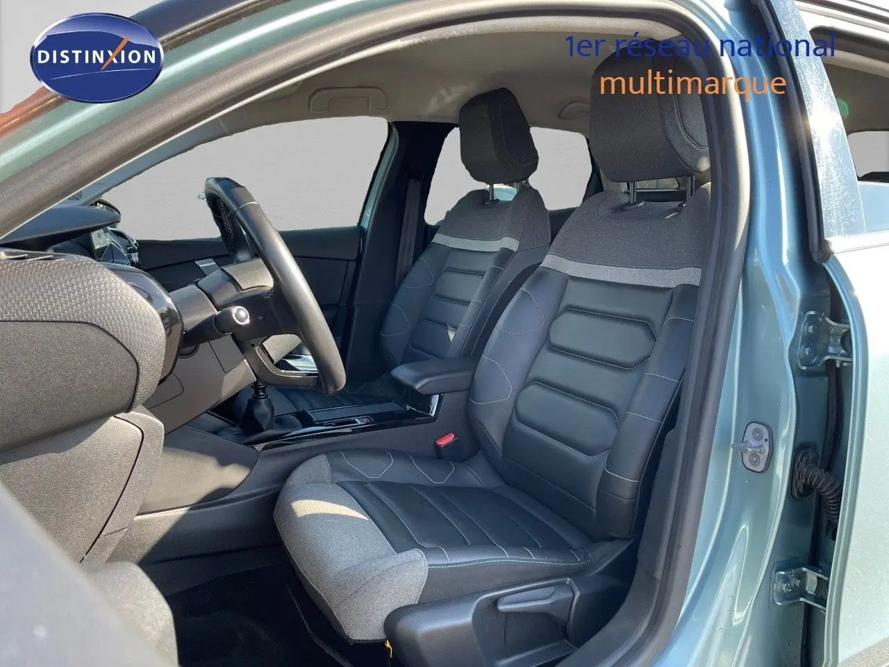 Vue intérieure côté gauche de la CITROEN C4 2021 bleu Iceland Metal avec sièges bi-matière cuir noir et tissu gris.