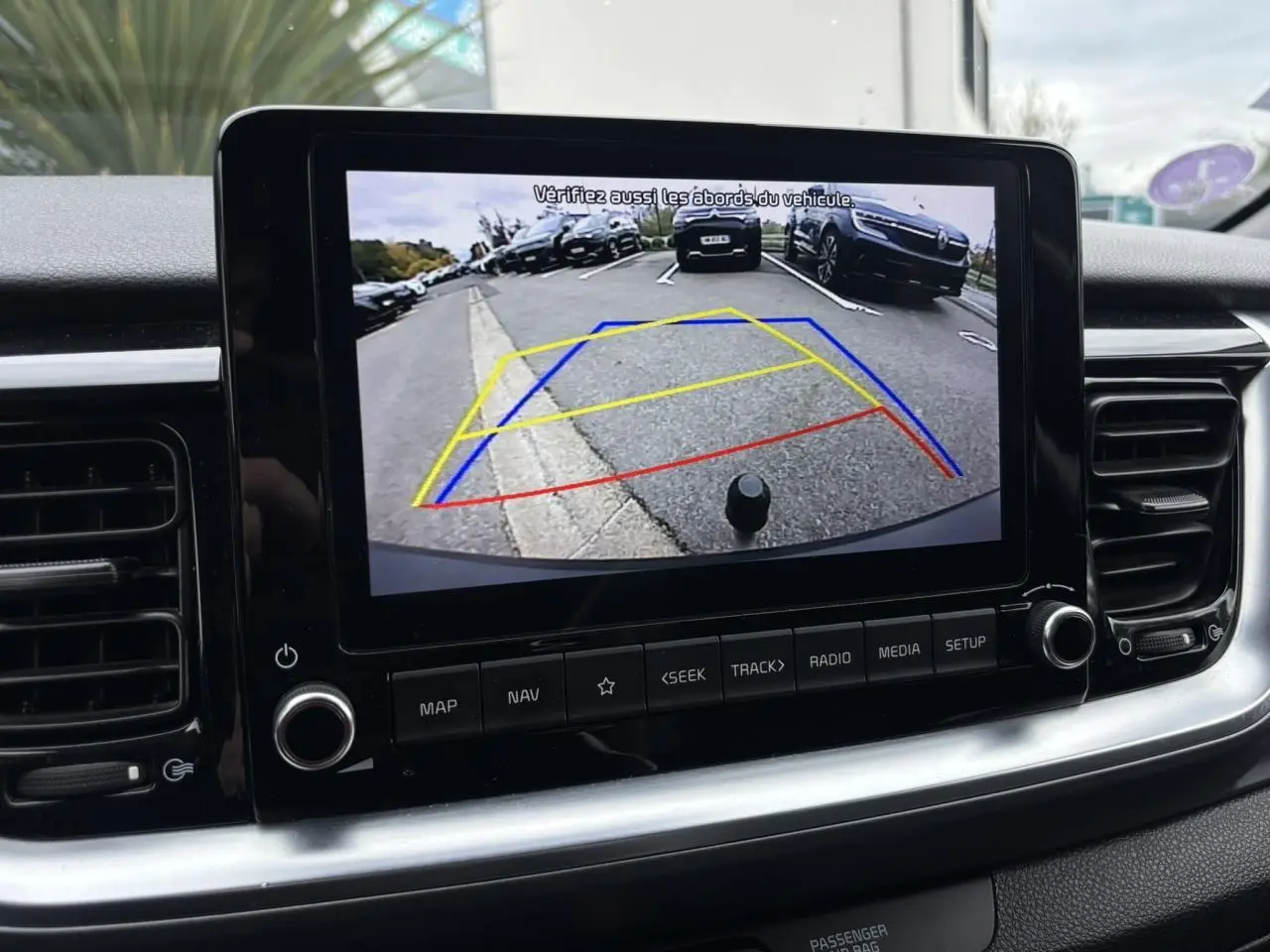 Affichage de la caméra de recul sur l'écran tactile du Kia Stonic rouge, vue intérieure du tableau de bord.