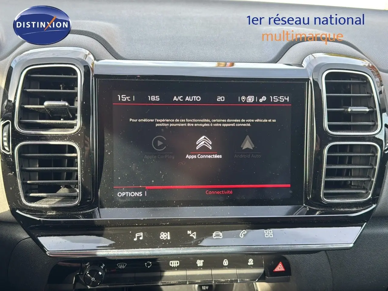 Écran tactile central du tableau de bord du Citroën C5 Aircross blanc nacré, avec commandes de climatisation visibles.