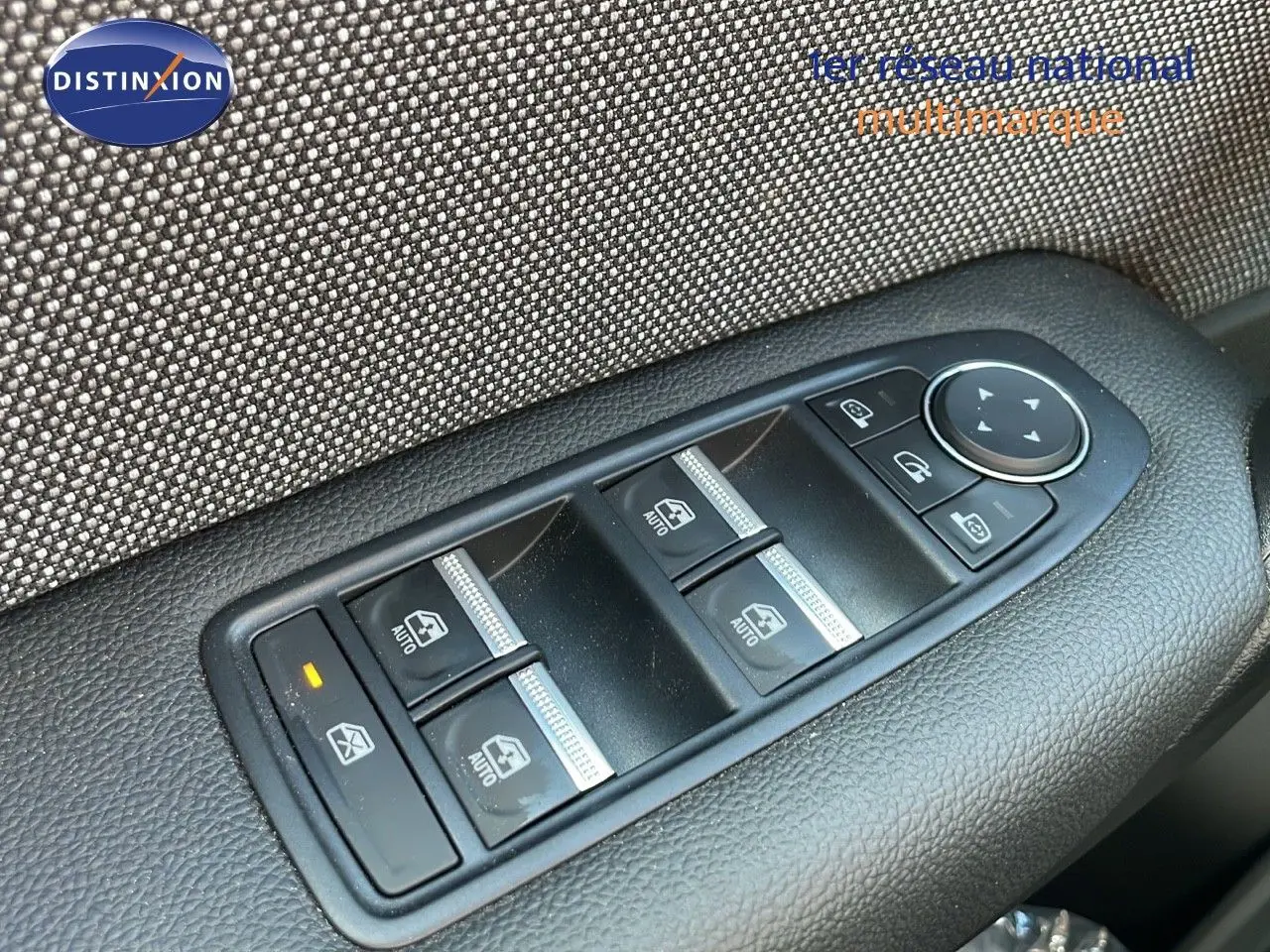 Gros plan sur les commandes de lève-vitres et rétroviseurs côté gauche du Renault Captur noir étoile métal 2025.