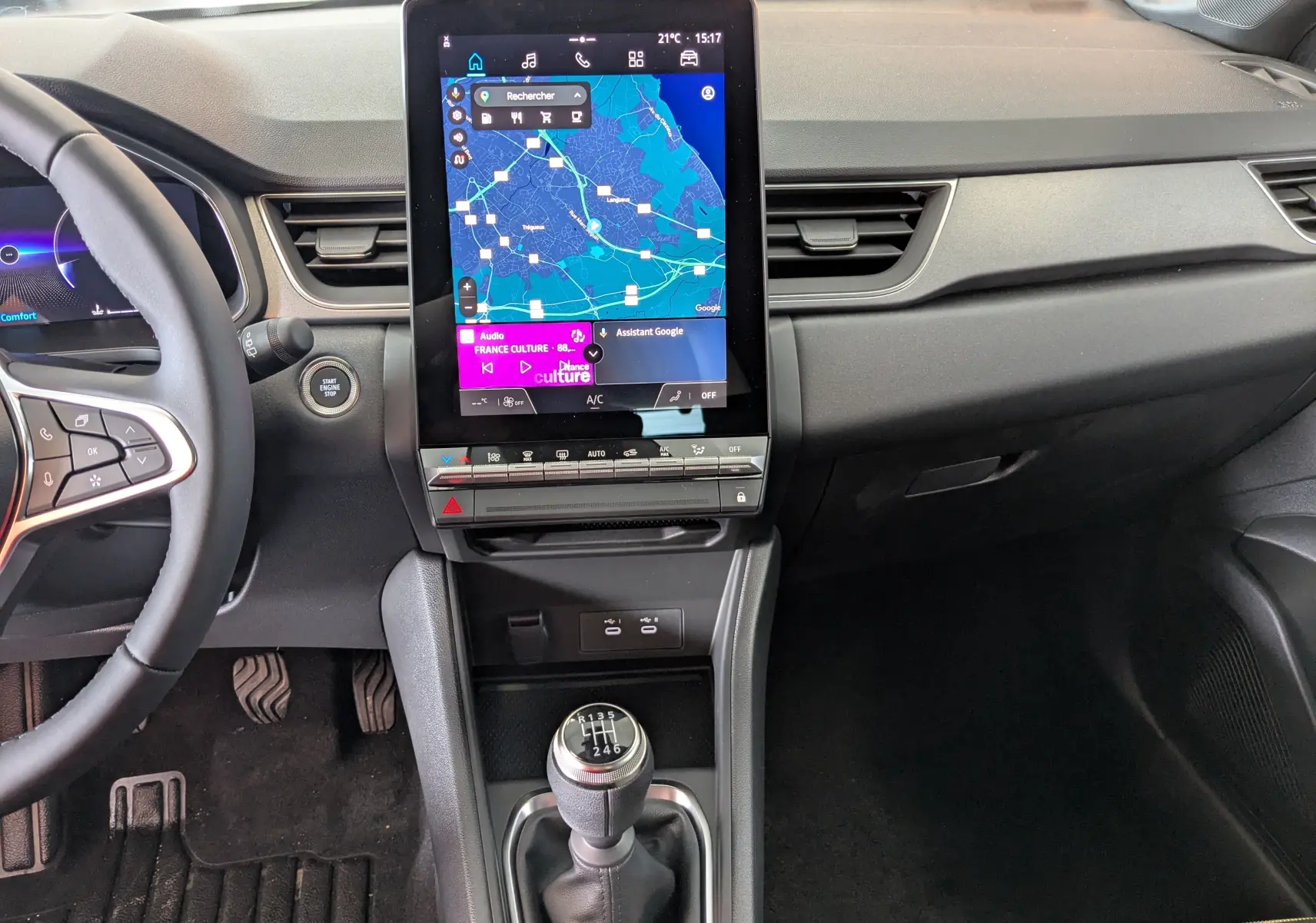 Vue intérieure du tableau de bord du Renault Captur 2025 avec écran tactile vertical et levier de vitesses manuel.