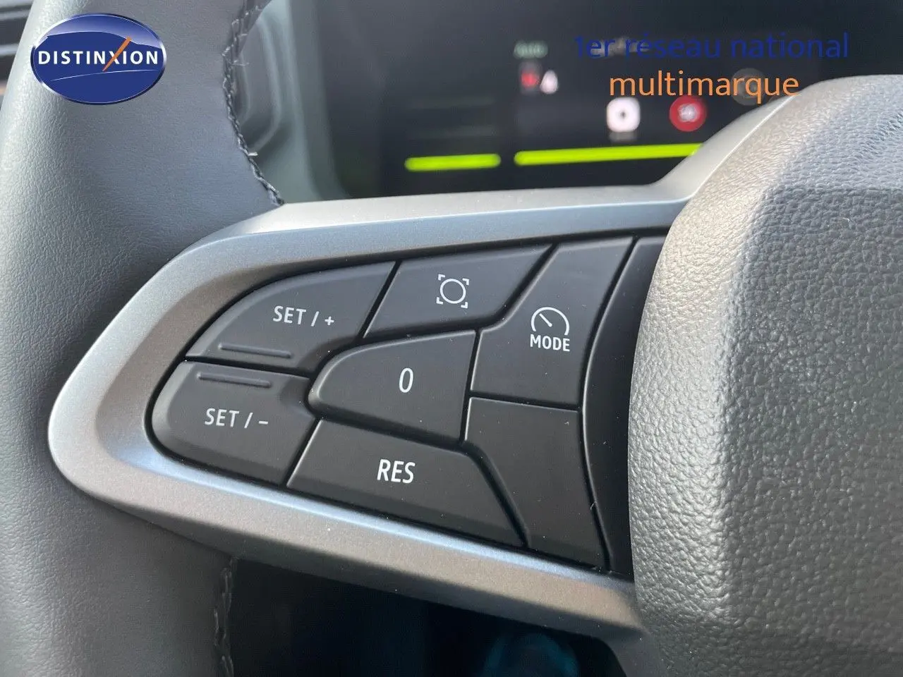 Gros plan sur les commandes au volant du Dacia Duster 2024 noir métal, mettant en valeur les boutons de régulateur de vitesse.