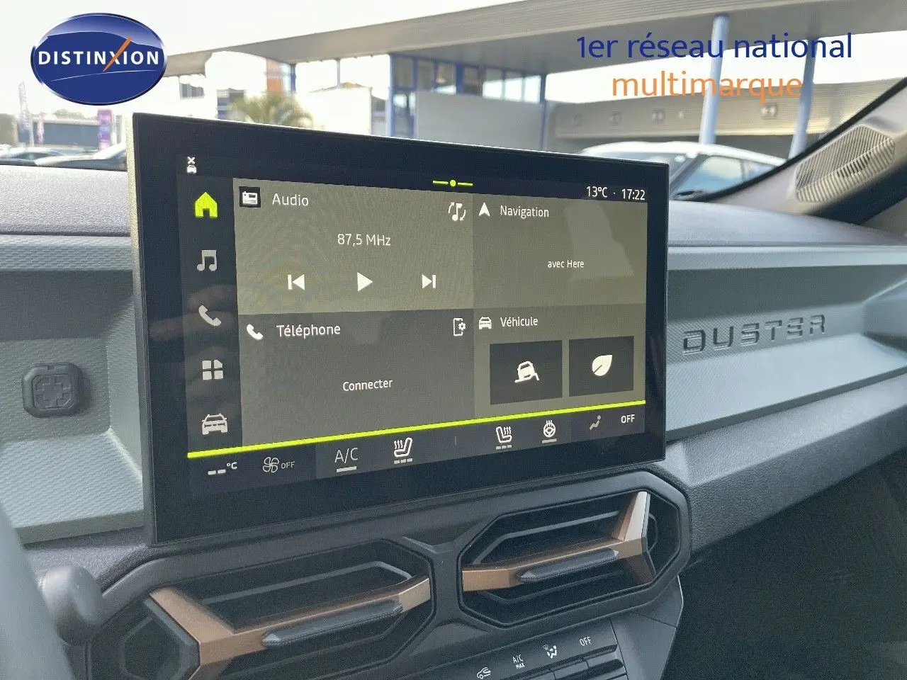 Vue rapprochée de l'écran tactile central et tableau de bord noir du Dacia Duster 2024 avec inscription DUSTER en relief.