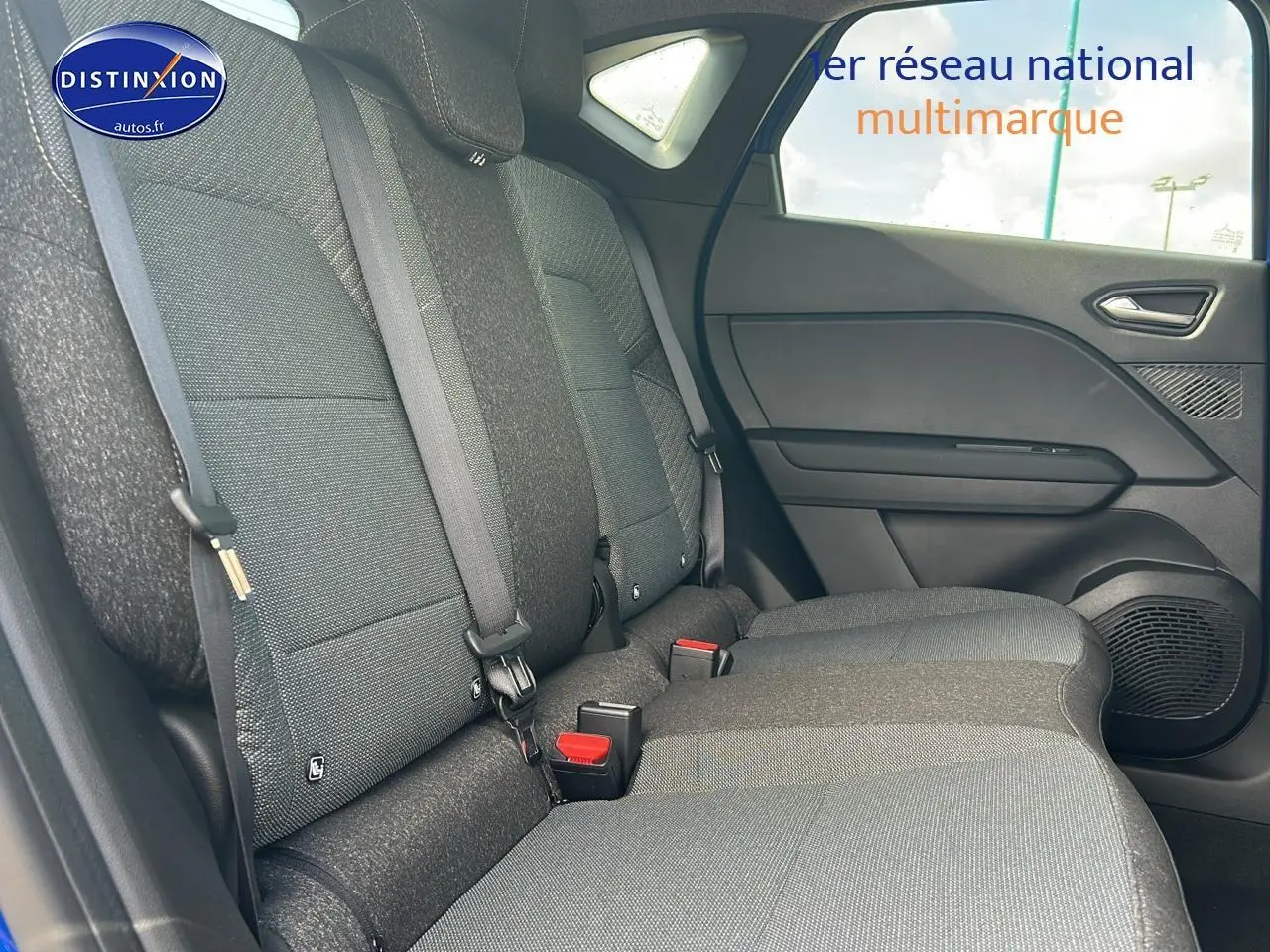 Vue latérale droite de la banquette arrière grise du Renault Captur 1.6 e-tech hybride 2025 avec ceintures et habillage de porte.