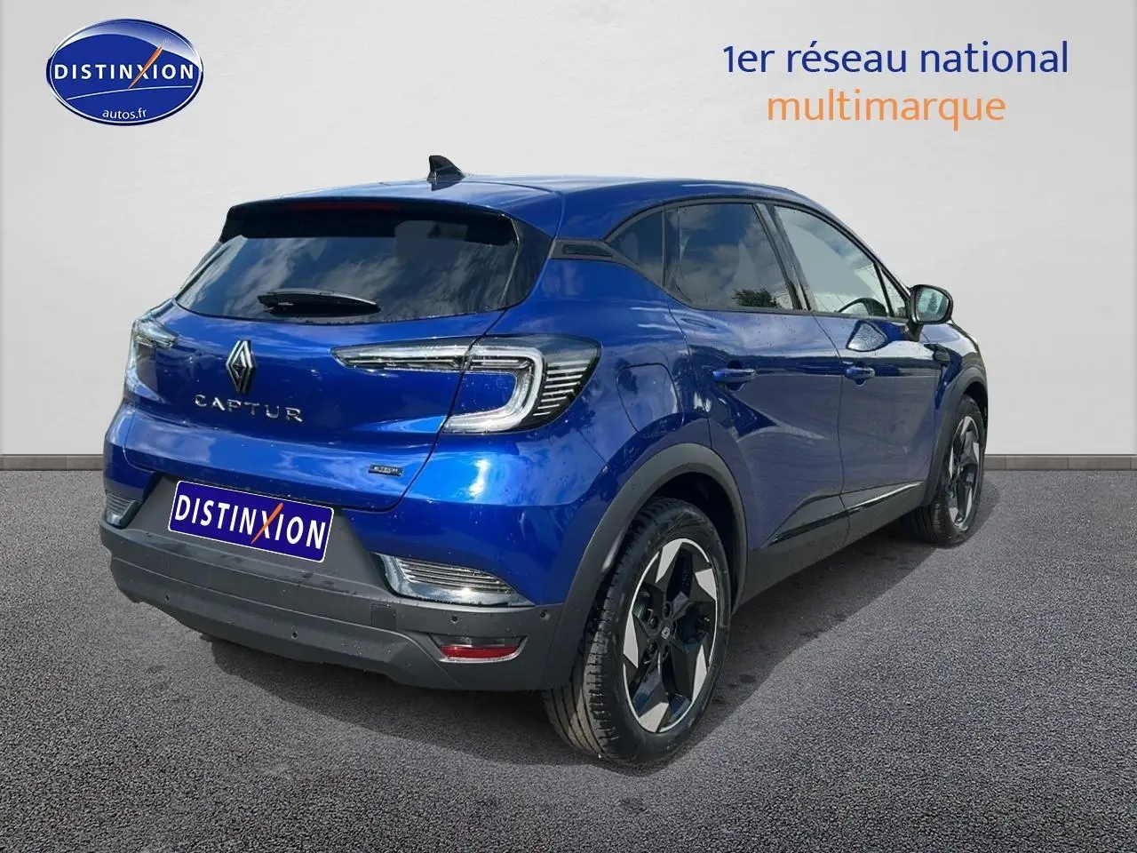 Vue 3/4 arrière droite du Renault Captur bleu iron avec jantes alliage et vitres teintées.