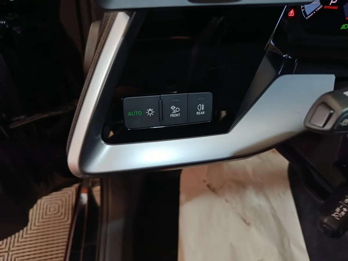 Détail du tableau de bord côté gauche de l’Audi A3 35 TDI 2023 avec commandes d’éclairage en mode auto.