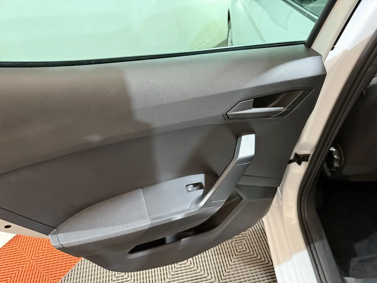 Vue intérieure sur la porte arrière droite blanche d'une SEAT IBIZA 1.0 TSI 110 FR avec garniture noire et poignée angulaire.
