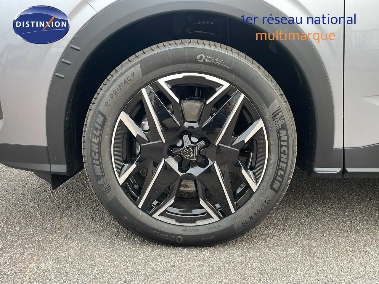 Gros plan sur la roue avant droite du Peugeot 5008 gris Artense métal avec jante noire et détails argentés.