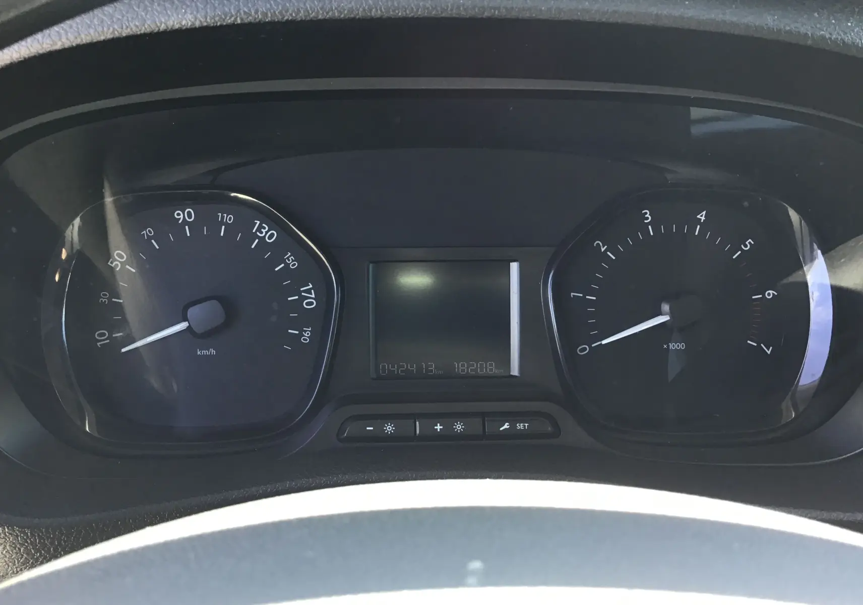 Vue rapprochée du tableau de bord noir de l'Opel Vivaro blanc 2023, affichant vitesse et compte-tours.