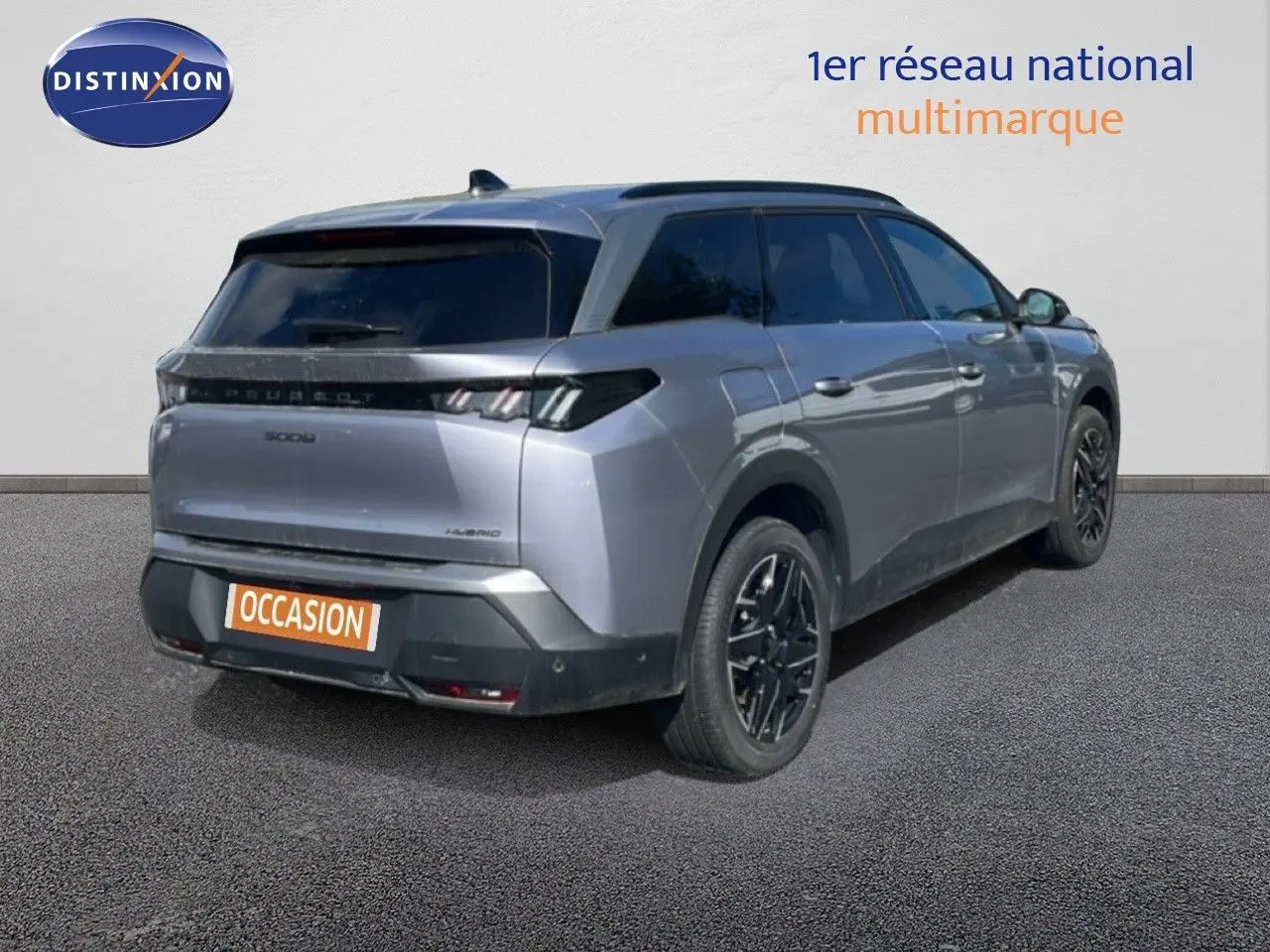 Vue 3/4 arrière droite d'un Peugeot 5008 gris Artense métal avec jantes noires et vitres teintées.