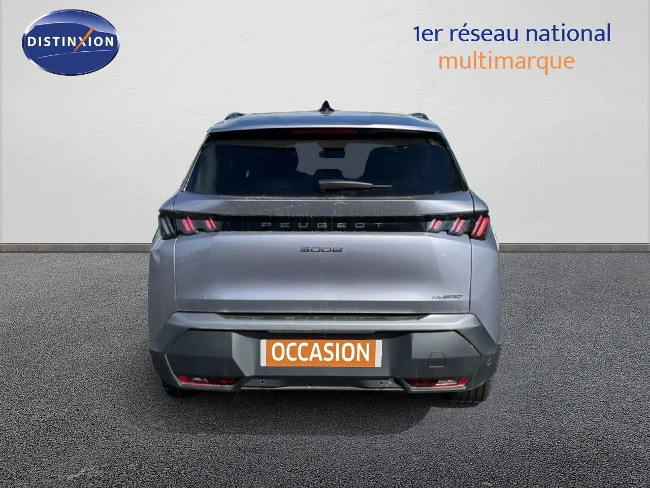 Vue arrière d'un Peugeot 5008 hybride gris Artense métal 2025 avec feux LED et plaque d'occasion visible.