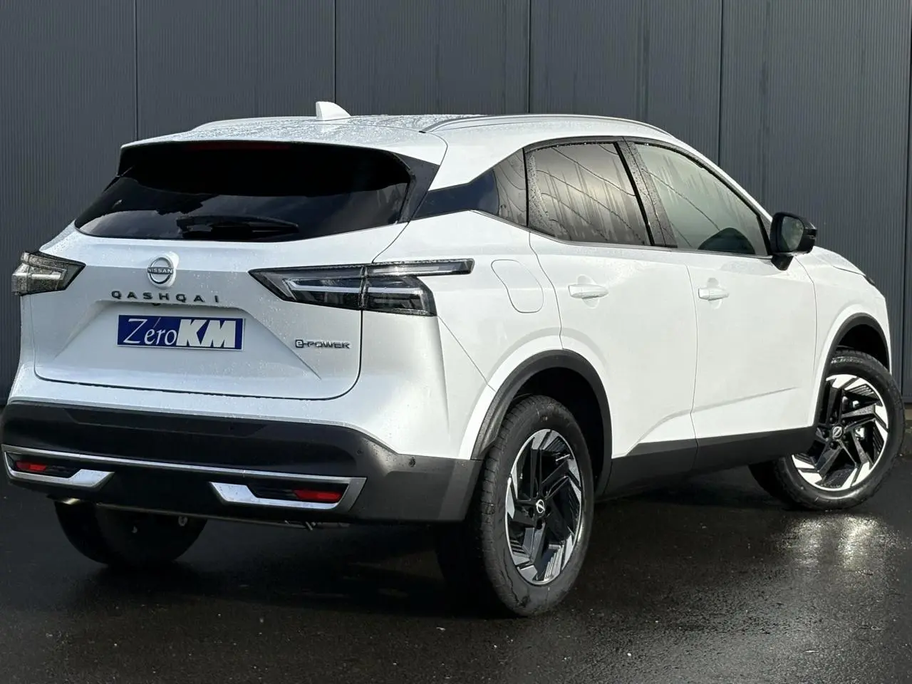 Vue 3/4 arrière droite du Nissan Qashqai blanc nacré e-Power avec jantes alliage et feux arrière LED.