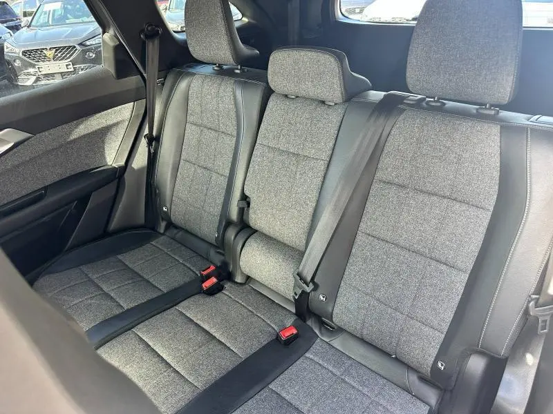 Vue intérieure sur la banquette arrière en tissu gris du Renault Espace 2024 avec ceintures de sécurité et appuie-têtes.