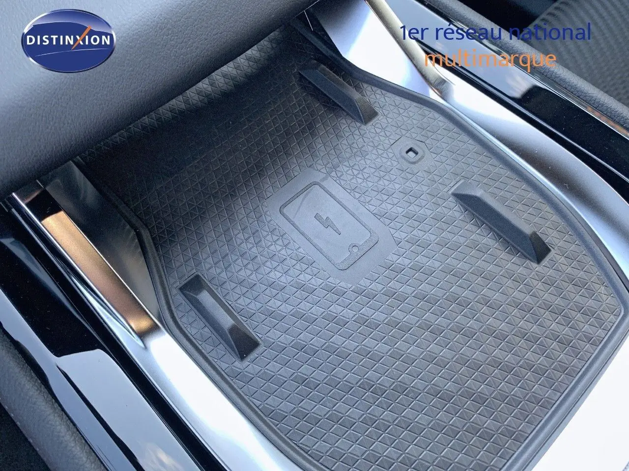 Surface de recharge sans fil noire au centre de la console d'une Renault Austral 2024 blanc métal toit noir.