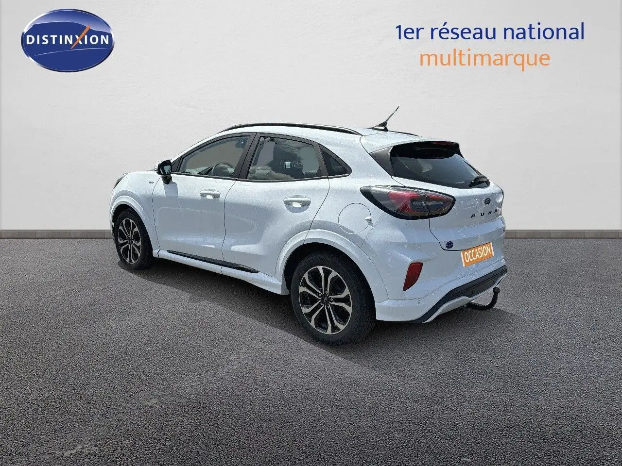 Ford Puma blanc en 3/4 arrière côté gauche, avec jantes alliage et feux arrière LED distinctifs.