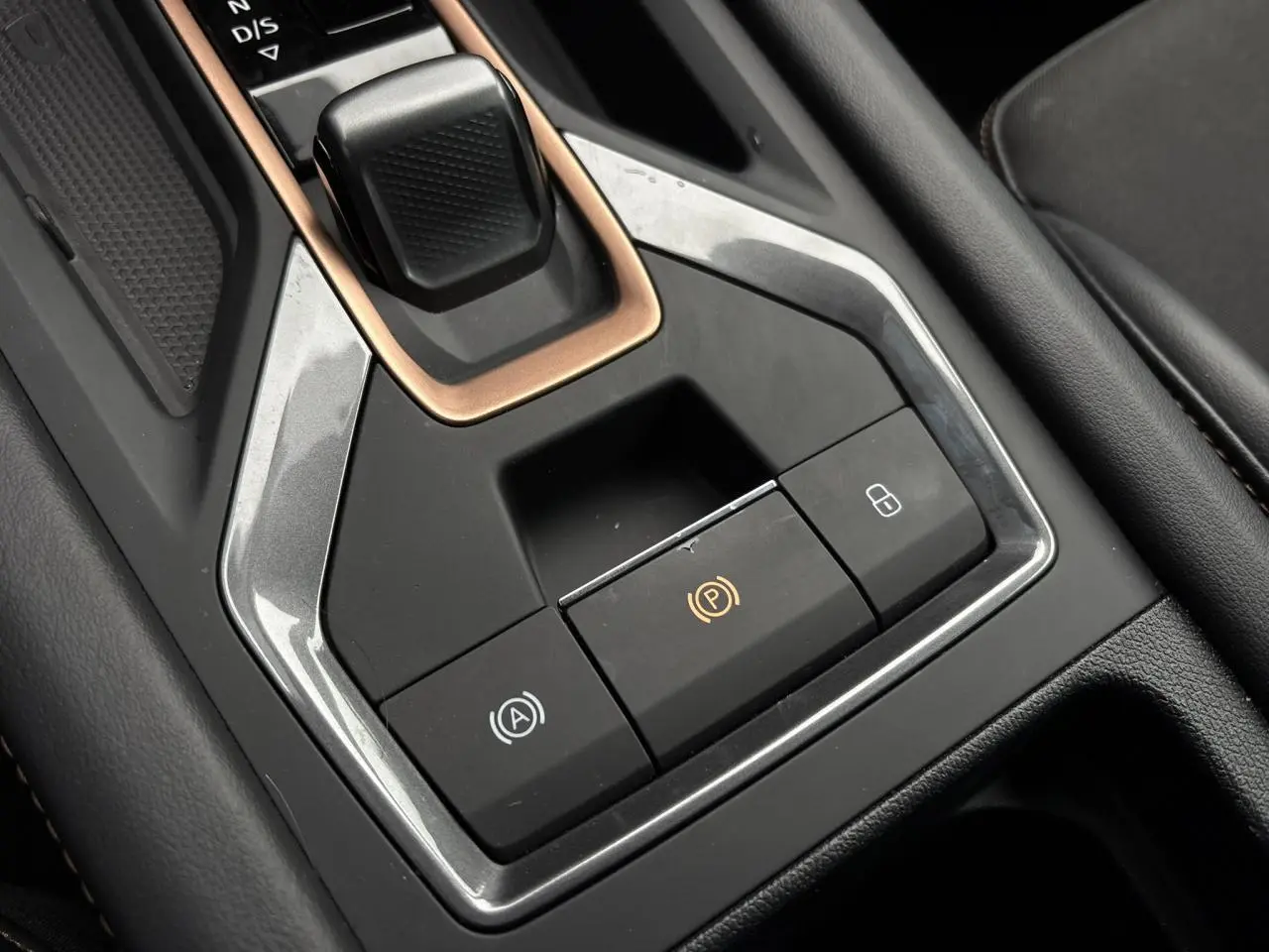 Gros plan sur la console centrale noire et gris Graphene avec levier de vitesses et boutons de frein à main électrique de la CUPRA LEON ST.