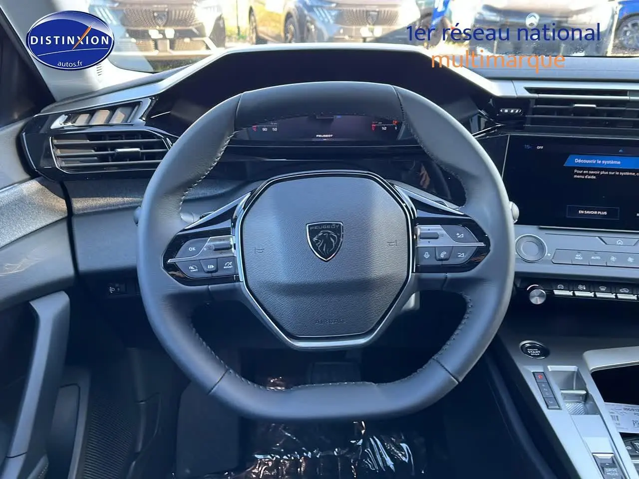 Vue frontale du volant multifonction noir du Peugeot 308 SW 2025 avec tableau de bord et écran tactile visibles.