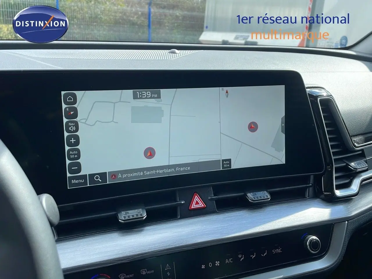Écran tactile central affichant la navigation dans l'habitacle noir du Kia Sportage gris foncé, vue de face.