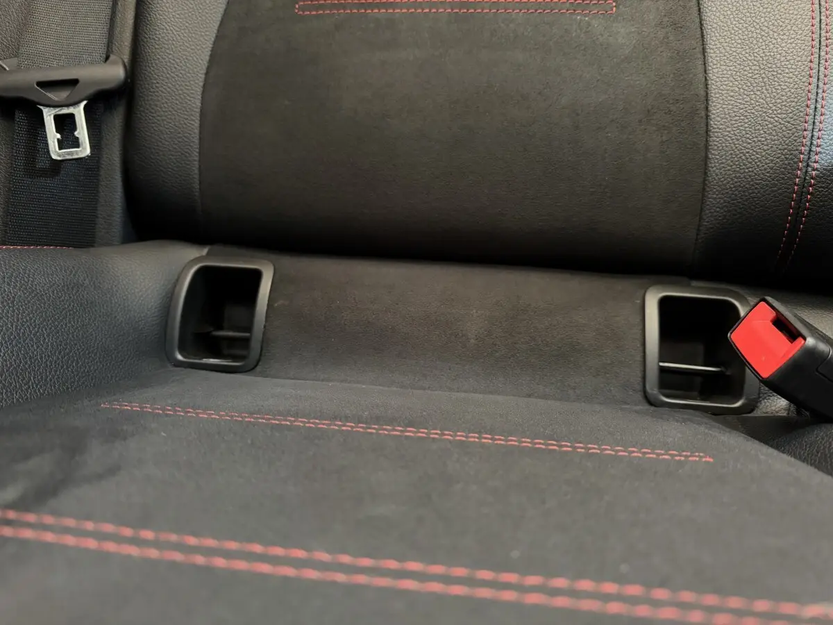 Gros plan sur la banquette arrière noire avec surpiqûres rouges et ceintures de sécurité du Mercedes GLA 250 e AMG LINE.