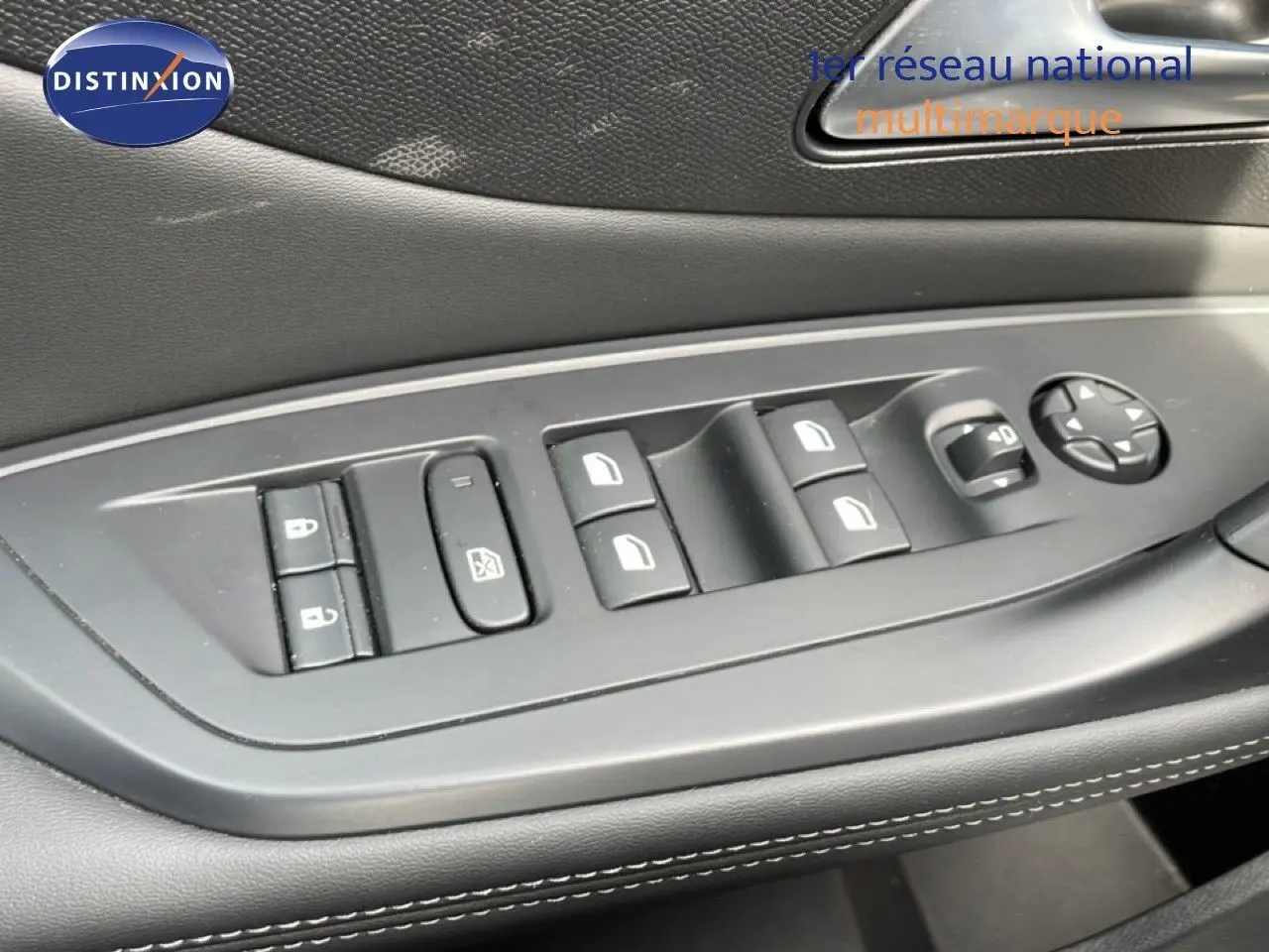 Détail des commandes de lève-vitres et rétroviseurs sur la porte côté gauche d’un Peugeot 308 SW noir métal 2025.