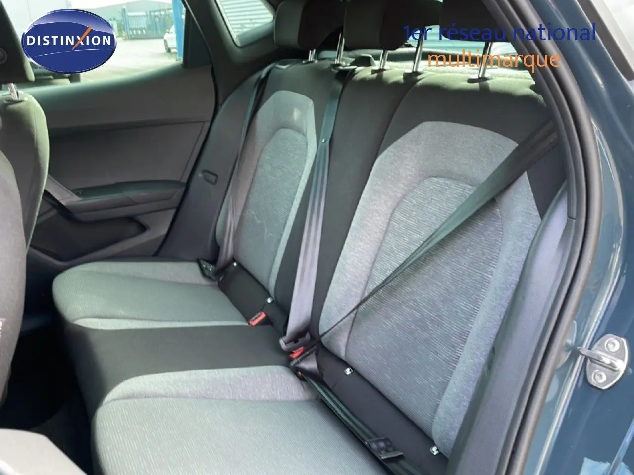 Vue intérieure côté droit des sièges arrière gris clair et foncé d'une SEAT Ibiza bleu fjord avec porte ouverte.