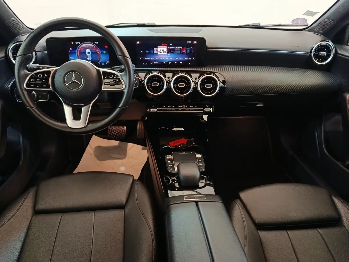 Intérieur noir de la Mercedes Classe A 200 Business Line 2021, vue de face sur le tableau de bord et volant multifonctions.