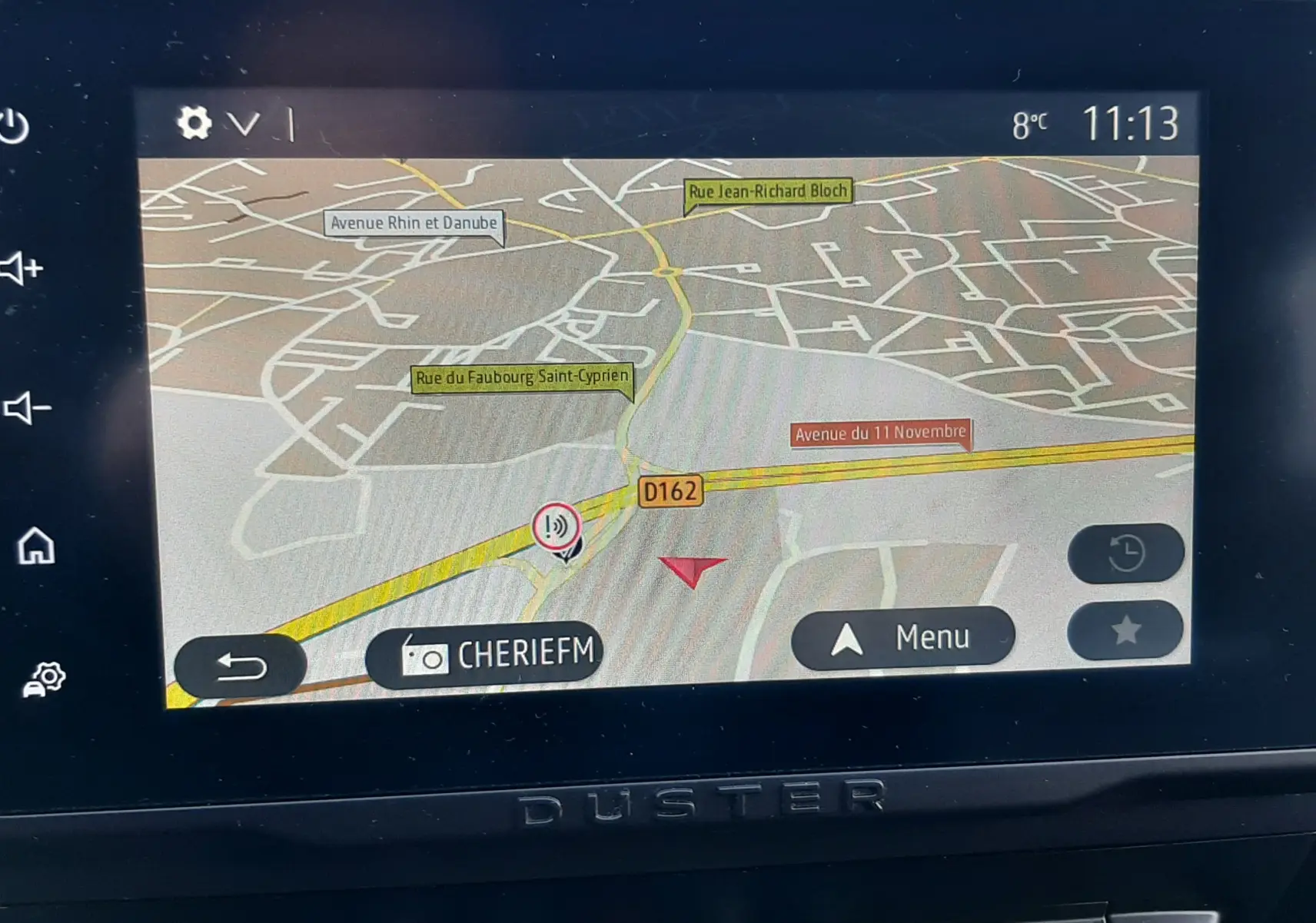 Écran tactile central du Dacia Duster 2023 affichant la navigation GPS avec carte et boutons de commande en dessous.