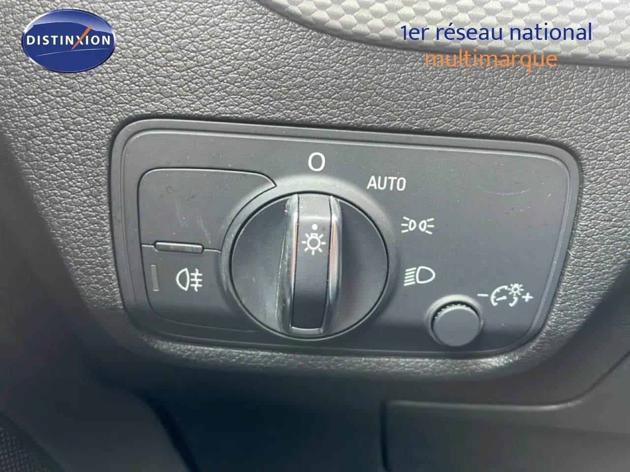 Gros plan sur le panneau de commande des phares de l’Audi Q2 30 TDI S-Line noir mito metal, intérieur noir.