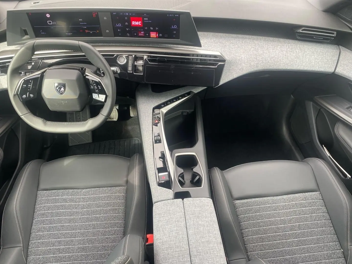 Vue intérieure de face du poste de conduite du Peugeot 3008 2025, volant cuir et tableau de bord numérique.