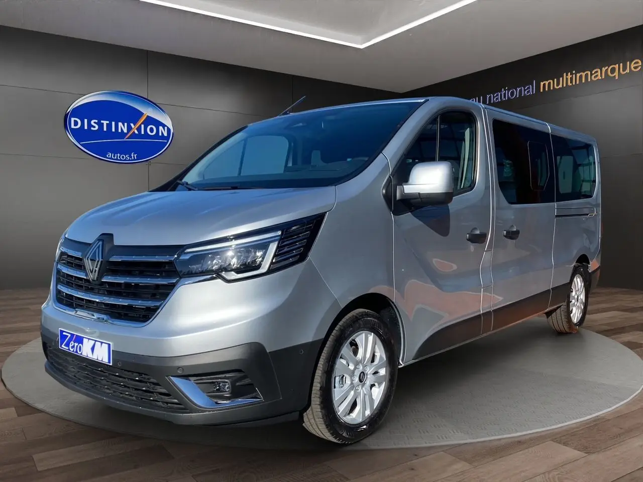 Renault Trafic Combi gris Highland en 3/4 avant droit avec portes latérales vitrées et jantes alliage 17 pouces.