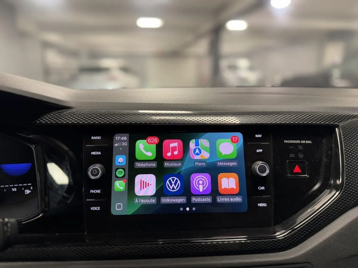 Vue rapprochée de l'écran tactile 8 pouces du Volkswagen Taigo gris, affichant l'interface Apple CarPlay colorée.