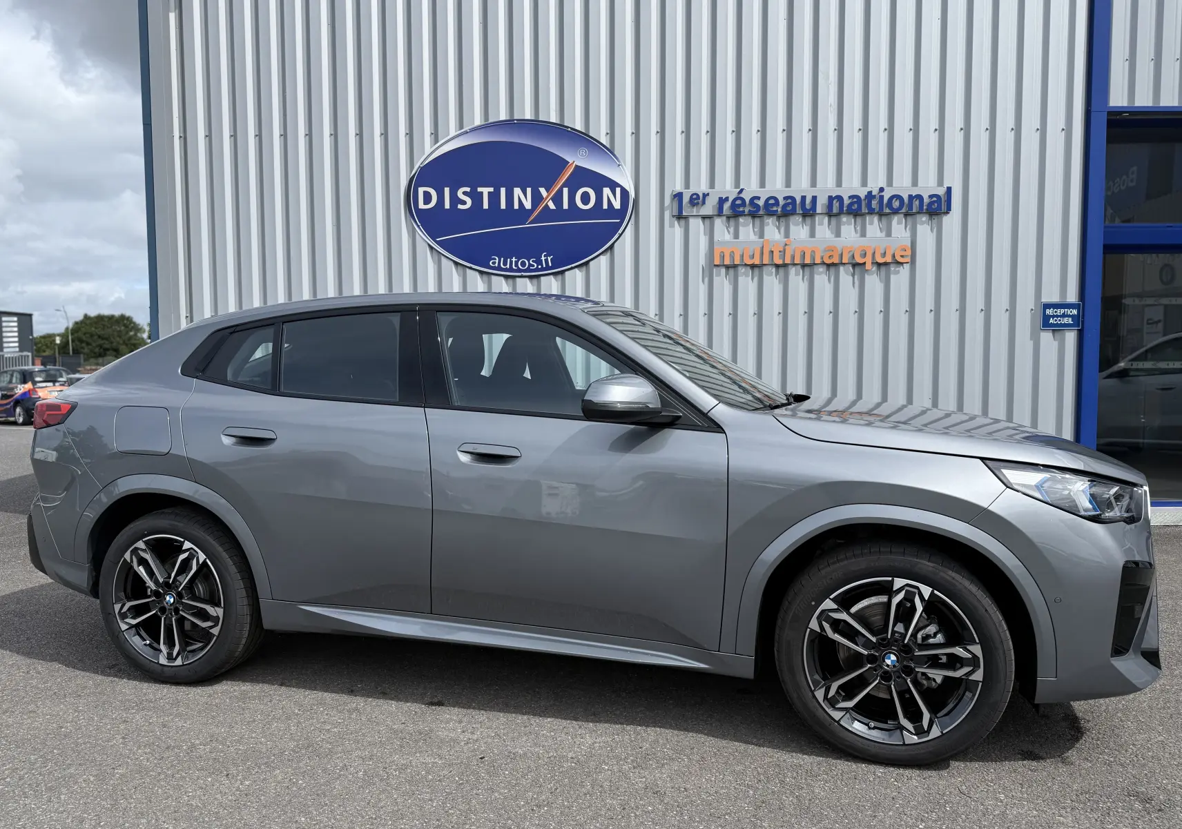 BMW X2 2025 gris Skyscraper vue de profil côté gauche, soulignant ses jantes noires et lignes dynamiques.
