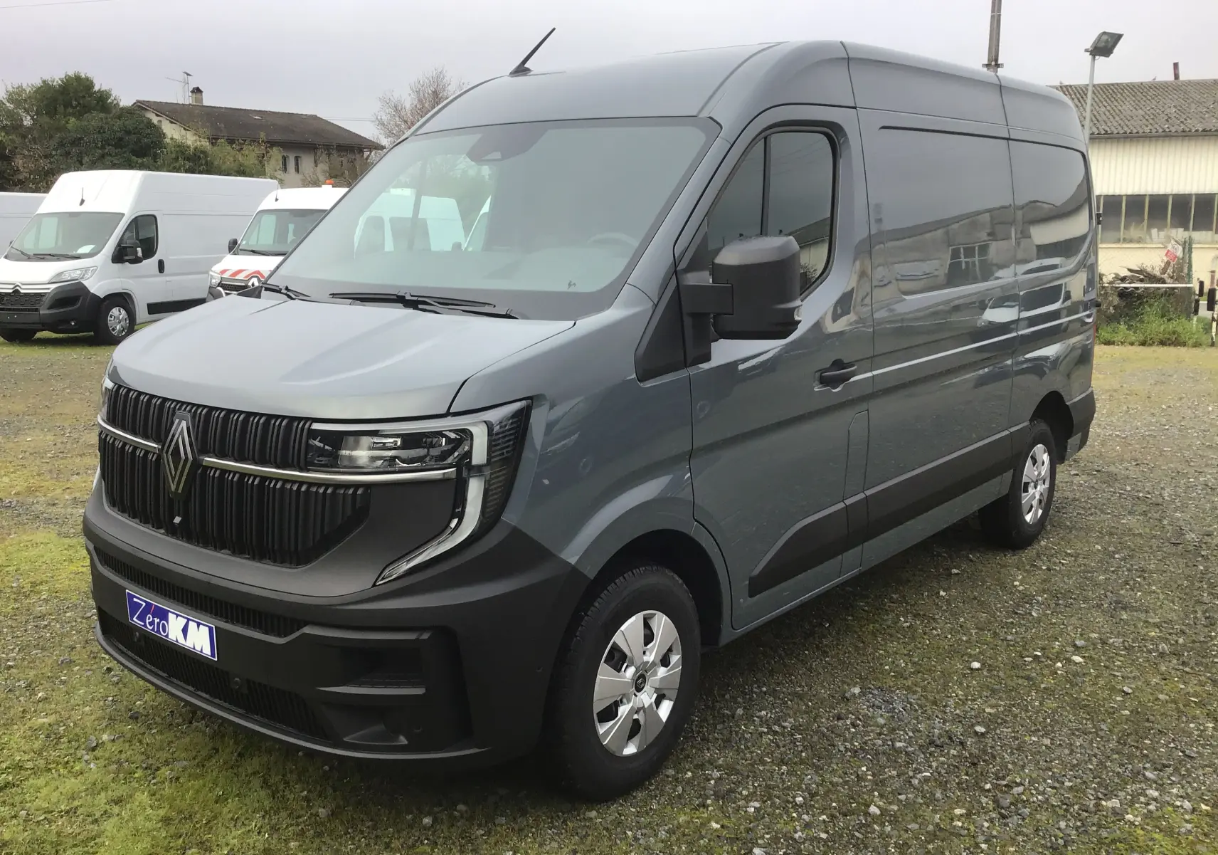Vue 3/4 avant droit du Renault Master gris urbain 2025 avec calandre noire et jantes acier argentées.