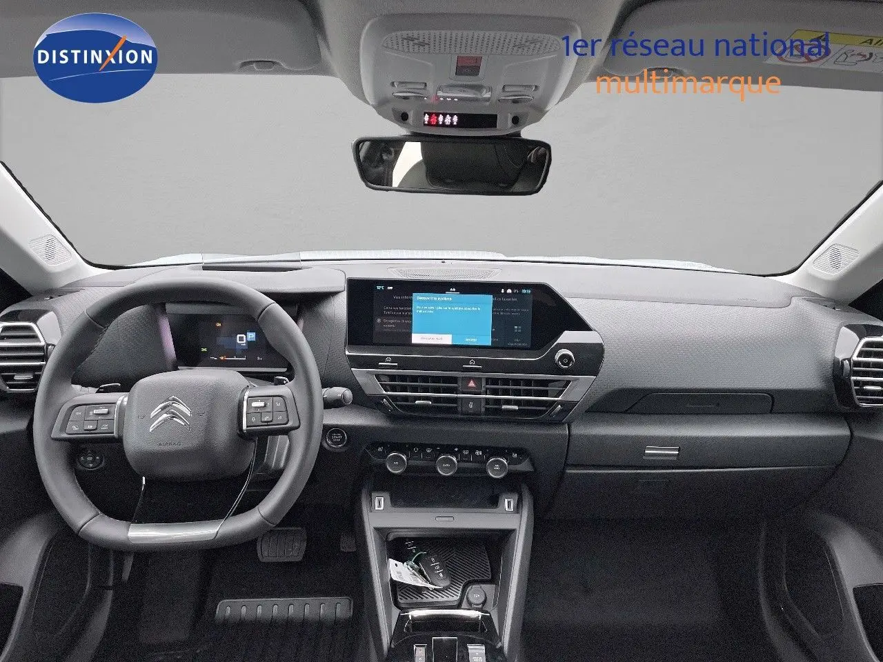 Intérieur moderne de la Citroën C4 2024, vue frontale du tableau de bord avec écran tactile et volant multifonction noir.