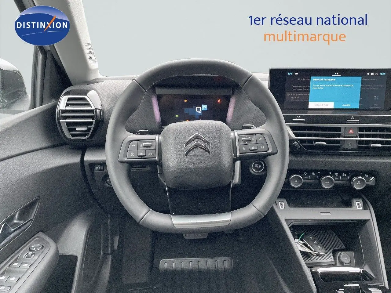 Vue intérieure centrée sur le volant multifonction et le tableau de bord numérique d'une Citroën C4 2024.