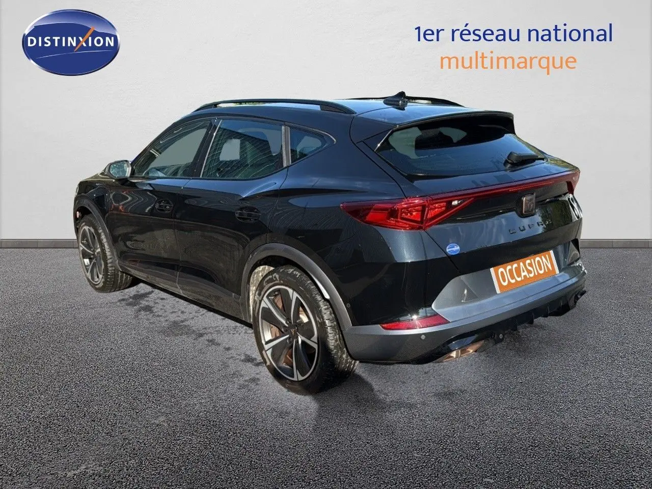 Vue 3/4 arrière droite d'une CUPRA Formentor noir minuit métal, avec jantes bi-ton et feux arrière allongés.