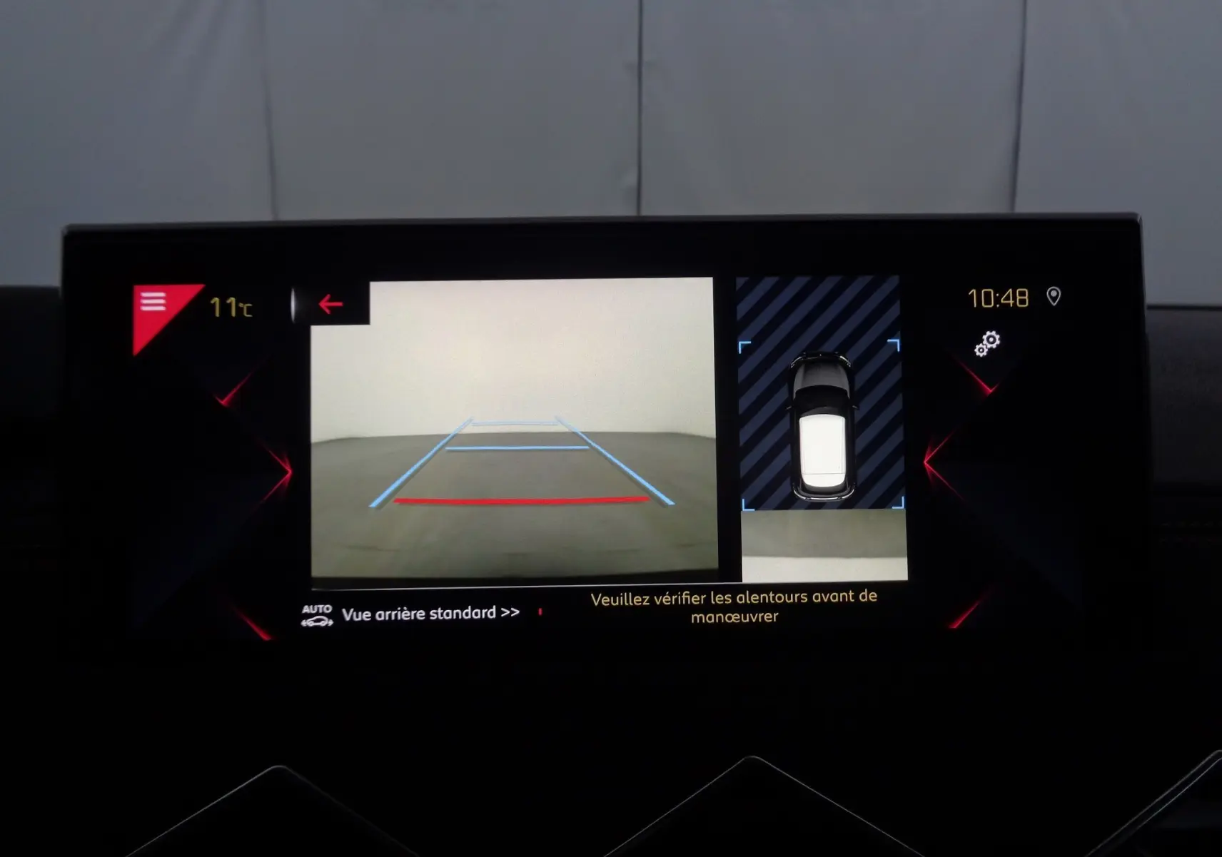 Écran multimédia du DS3 Crossback montrant la caméra de recul avec lignes de guidage et vue aérienne du véhicule.