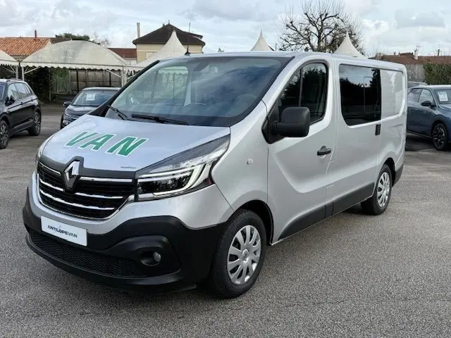 Renault Trafic Fourgon gris platine vu en 3/4 avant droit avec marquage VAN sur le capot.