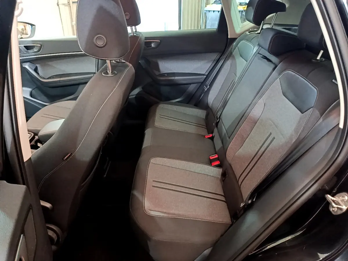 Vue intérieure côté droit sur la banquette arrière grise et noire du SEAT Ateca noir 2022.