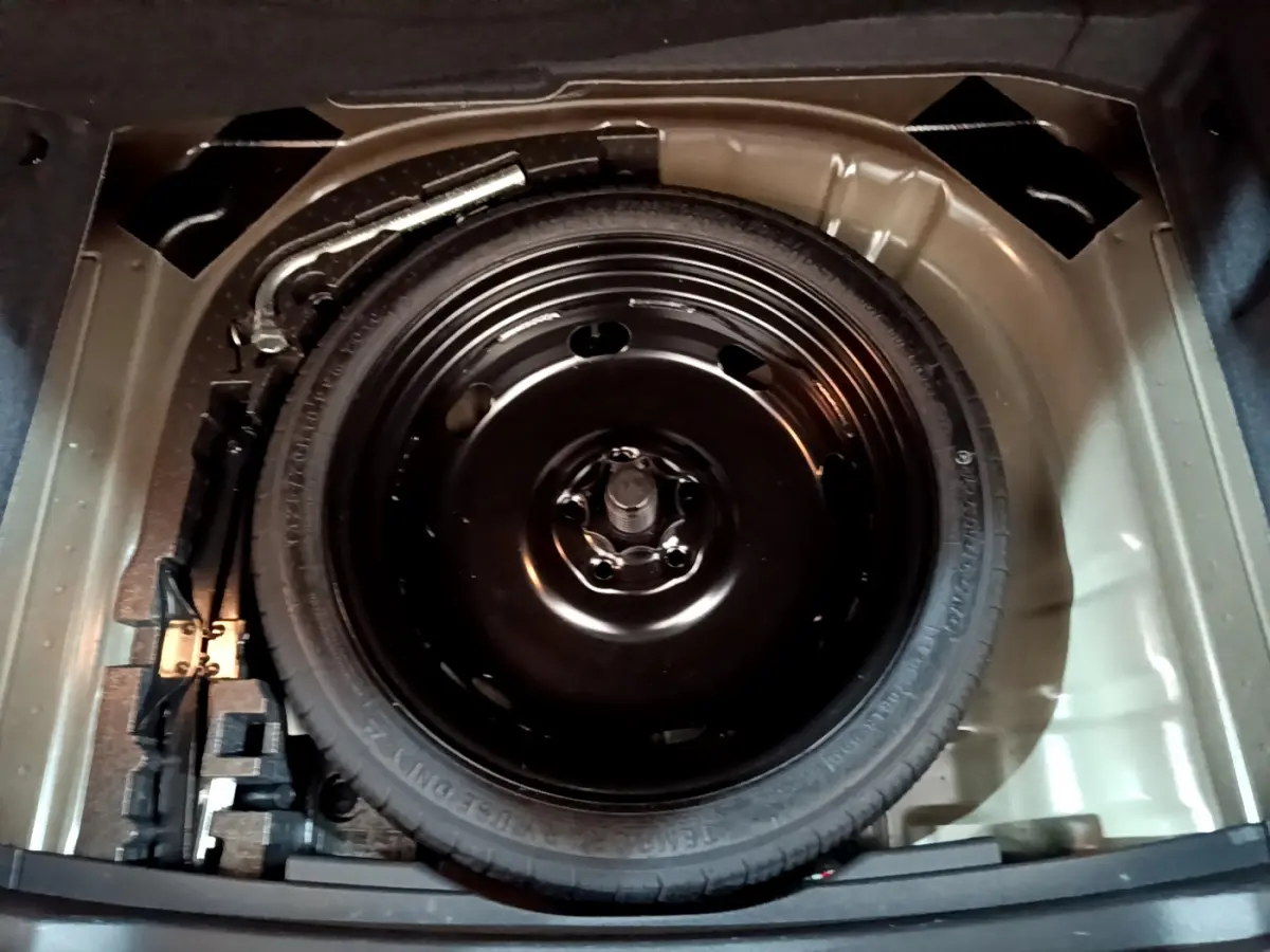 Roue de secours galette noire dans le coffre d'un SEAT Ateca 2.0 TDI 150 DSG7 2022, vue de dessus.