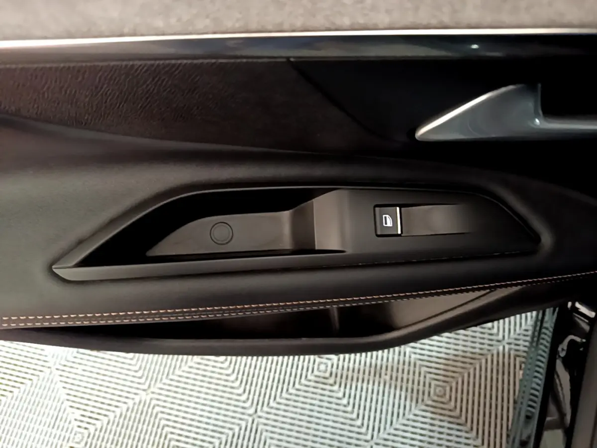 Poignée intérieure côté gauche noir mat avec bouton de verrouillage sur la portière d'une Peugeot 3008 2023.