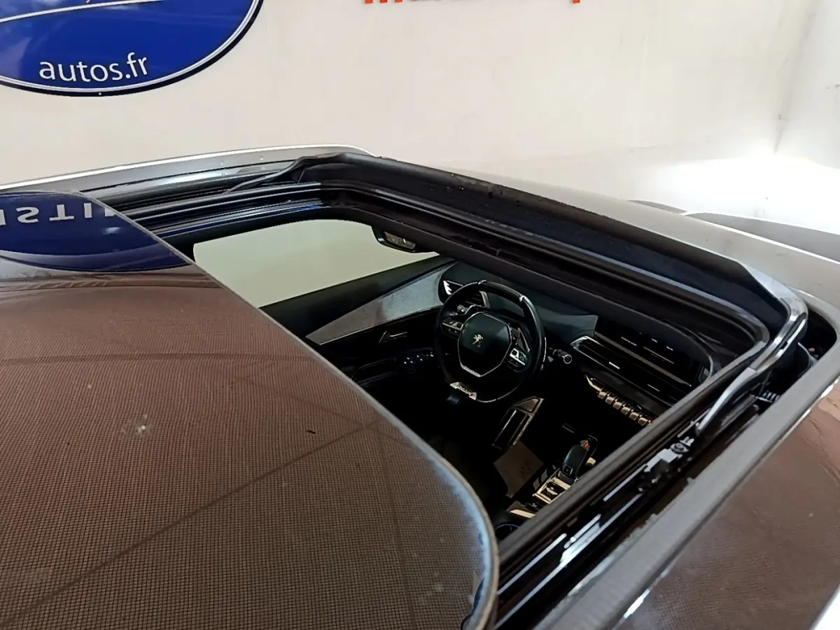 Vue plongeante sur l'intérieur noir du Peugeot 5008 GT 2021, avec volant multifonctions et tableau de bord digital.