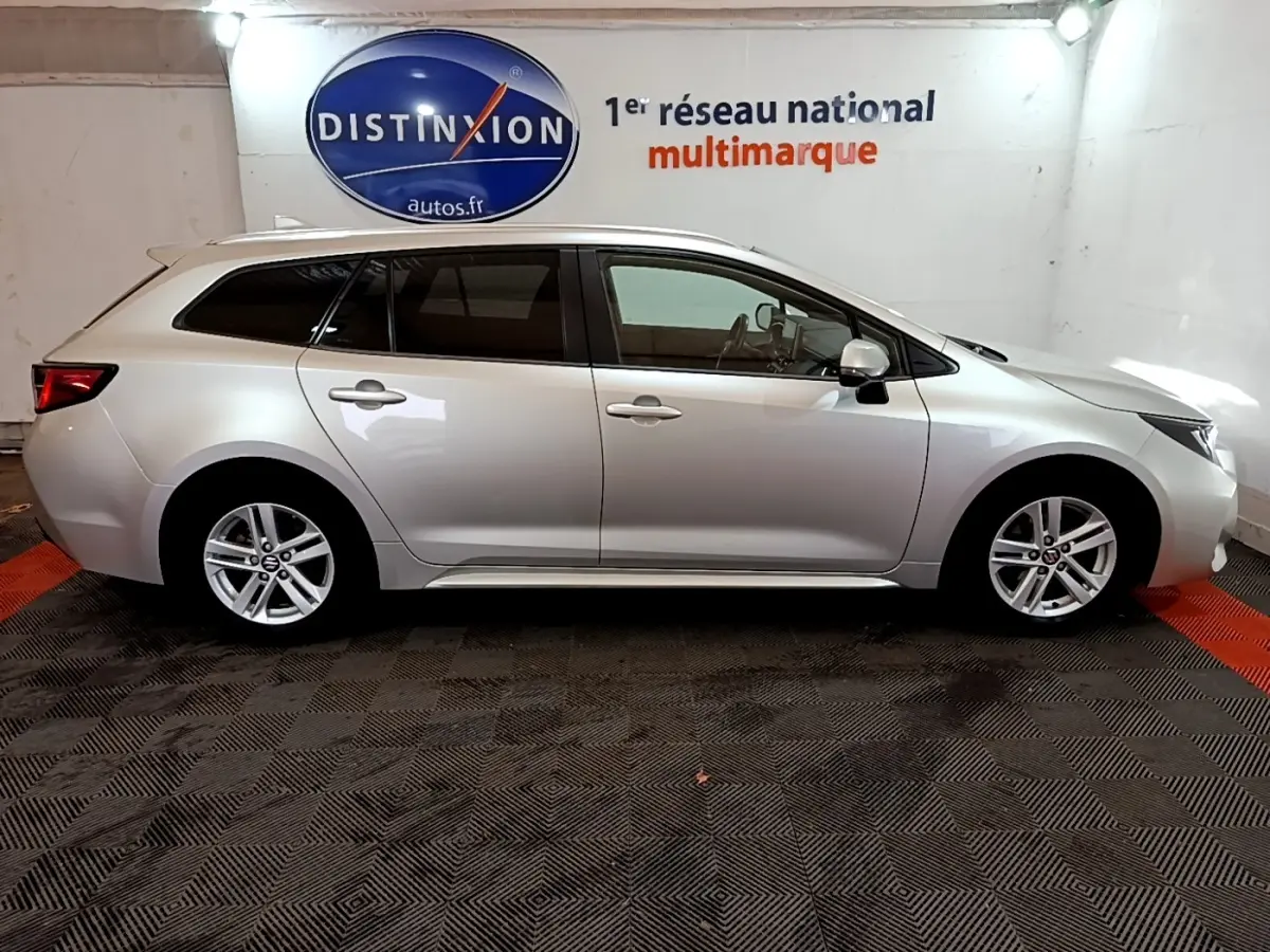 Vue latérale droite d'une Suzuki Swace gris clair 2021 en version hybride, avec jantes alliage et vitres teintées.