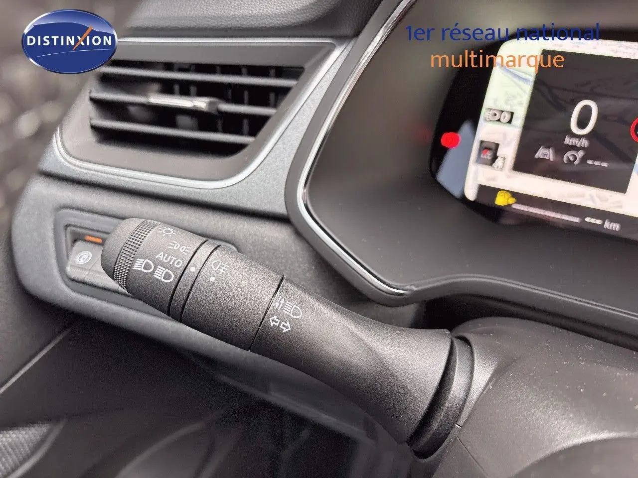 Gros plan sur la commande des feux et clignotants du tableau de bord gris noir du Renault Captur hybride 2025.