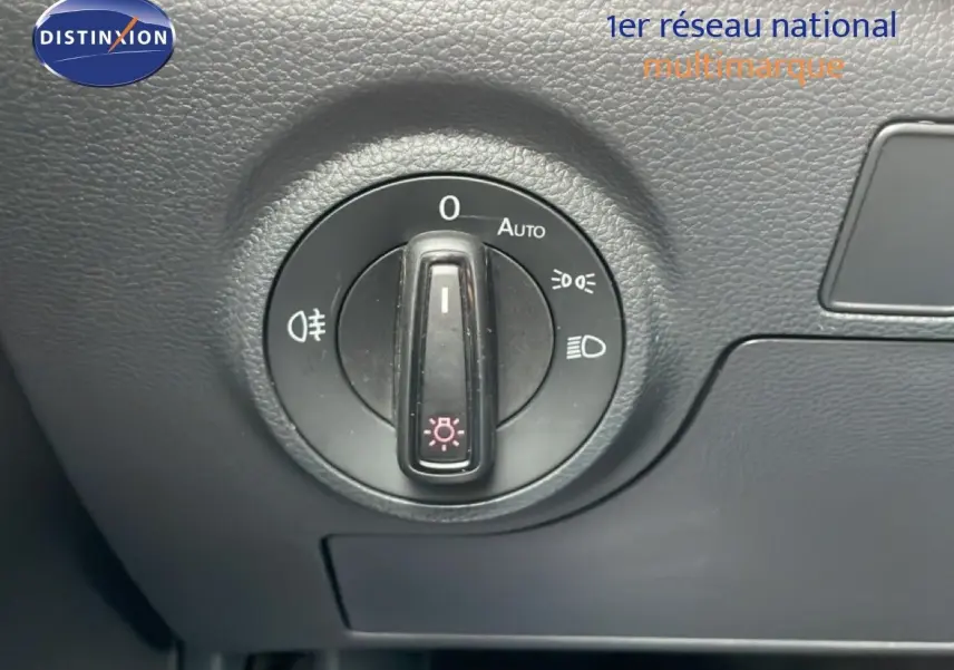 Gros plan sur la molette de commande des phares dans l’habitacle noir du SEAT Arona 2025.