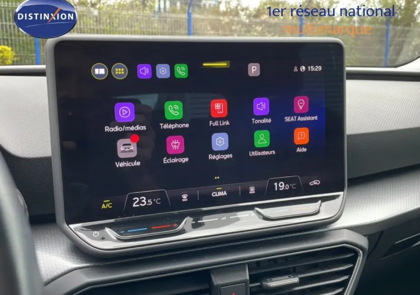 Vue intérieure centrée sur l'écran tactile du tableau de bord d'une SEAT LEON ST gris magnétique 2025.