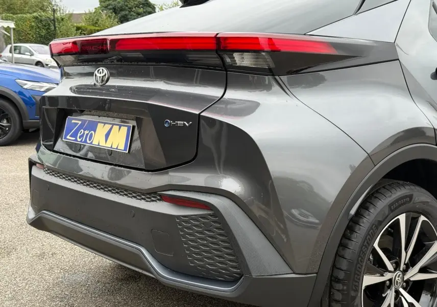 Vue 3/4 arrière droite du Toyota C-HR 1.8 140CH STYLE gris atlas avec feux LED et jantes alliage noires.